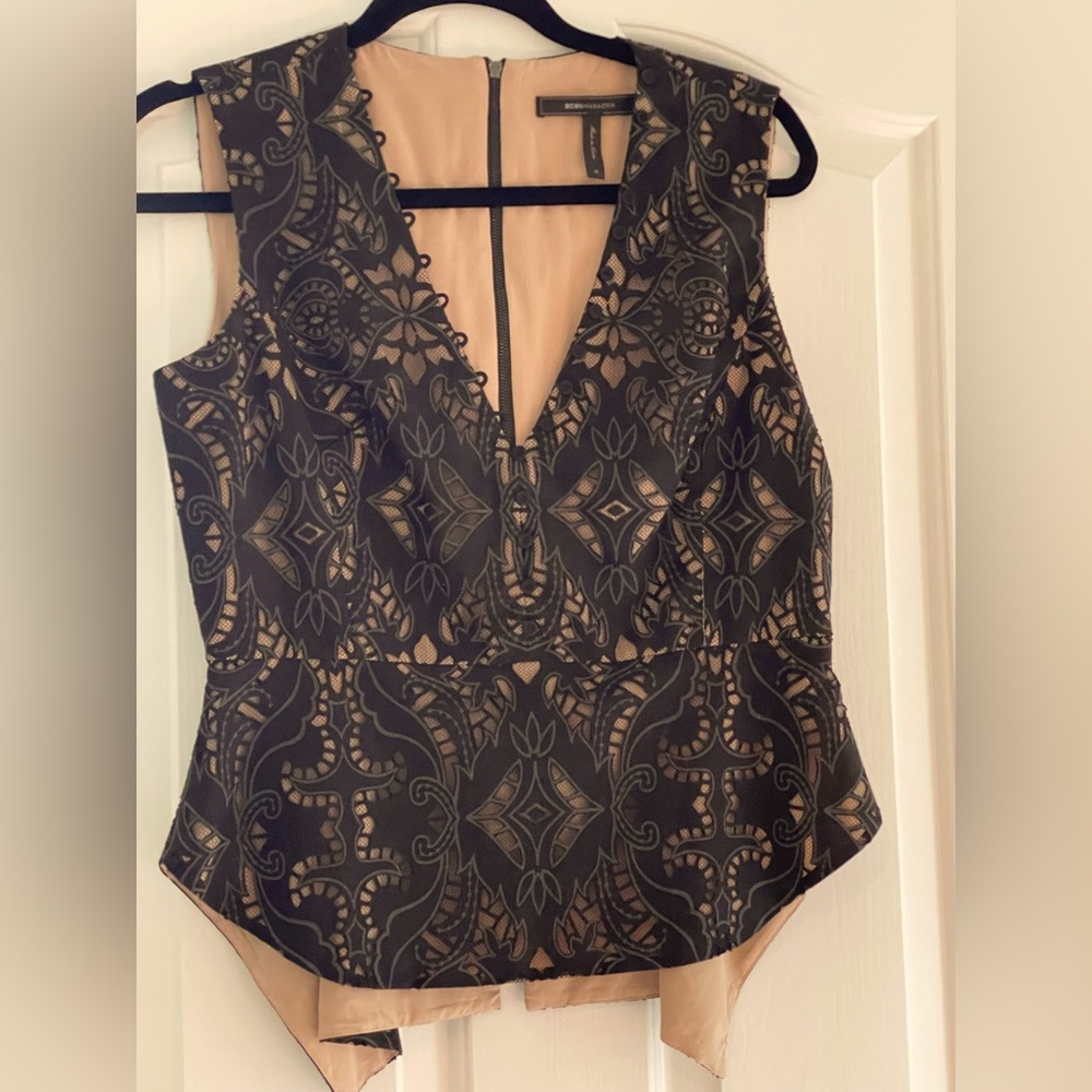 BCBG lace top. Flattering style that come in in the waist.